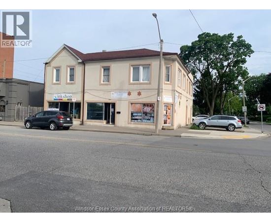 A street view with a building that has a sign that says "link shop".