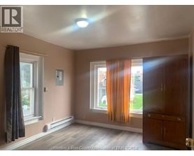 A room with a window and curtains.