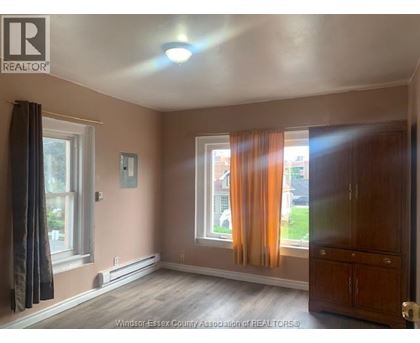 A room with a window and curtains.