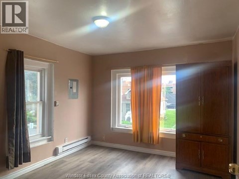 A room with a window and curtains.
