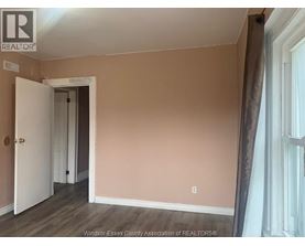 A room with a doorway leading to another room.