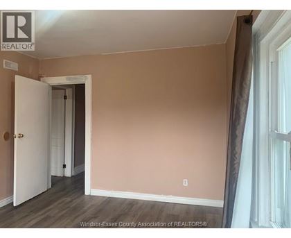 A room with a doorway leading to another room.