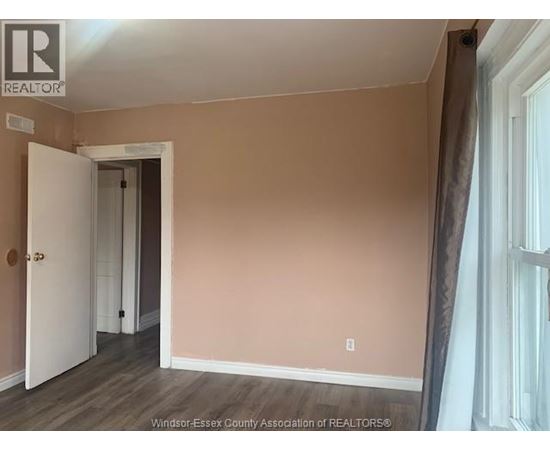 A room with a doorway leading to another room.