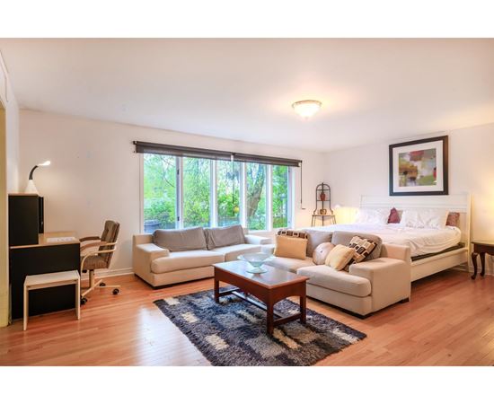 A living room with a white couch and a coffee table.