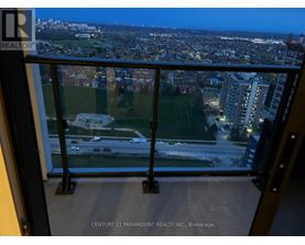 A view from a balcony overlooking a city at night.