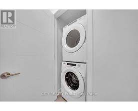 A white washing machine in a small laundry room.