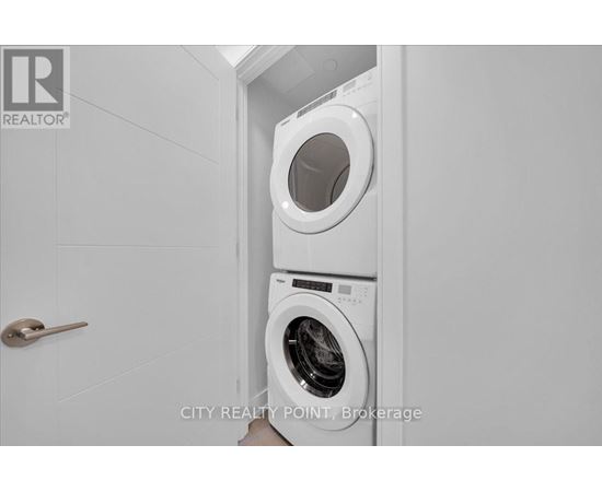 A white washing machine in a small laundry room.