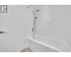 A white bathroom with a tub and shower.