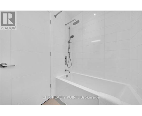 A white bathroom with a tub and shower.