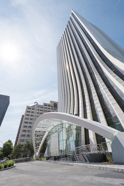 A modern building with a curved glass entrance.