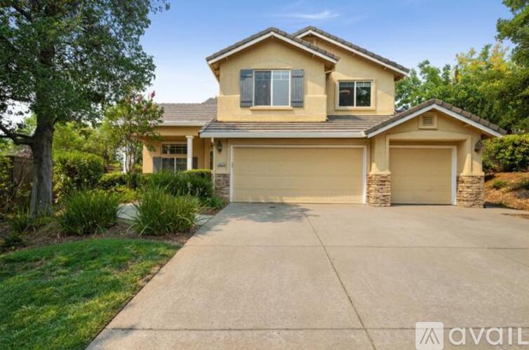 A two-story house with a garage is available for sale.