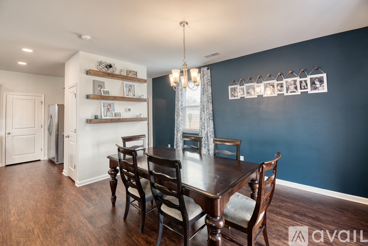 A dining room with a wooden table and chairs.