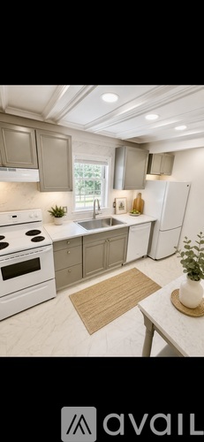 A white house with green shutters is for sale.