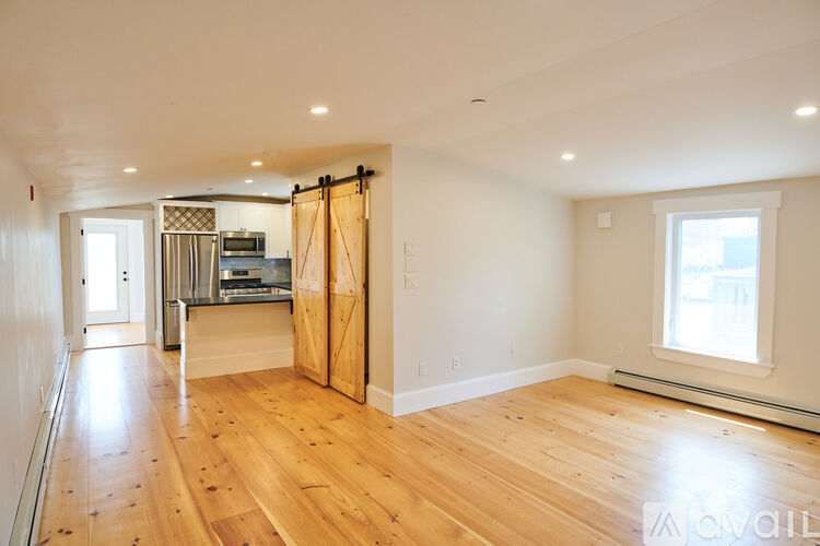 A room with wooden floors and a large open space.
