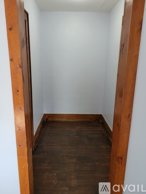 A room with wooden floors and white walls.