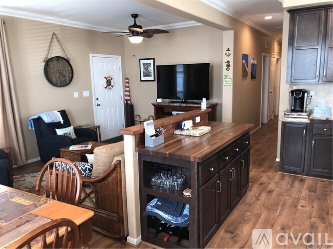 A living room with a wooden floor and furniture.
