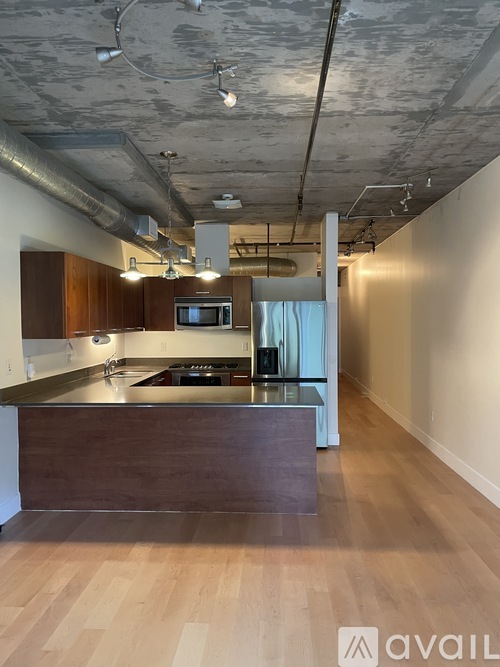 A kitchen with a wooden counter and a microwave on top.