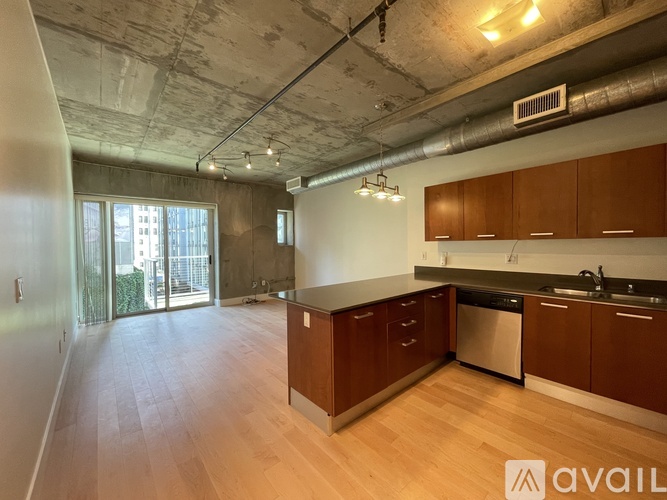 A kitchen with wooden cabinets and a dishwasher.