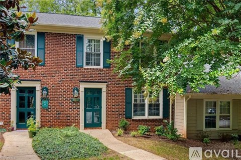 A house with a green door and a brick facade.