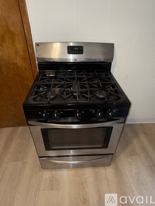 A modern stainless steel gas range with an oven built into it.