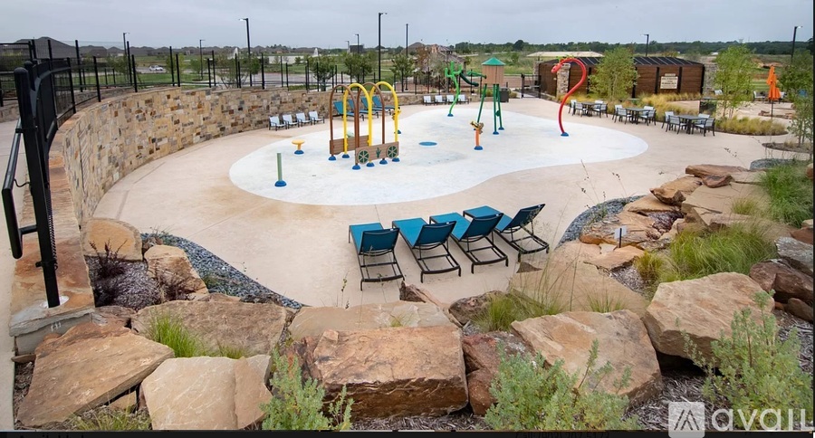 A playground with a roundabout and a slide.