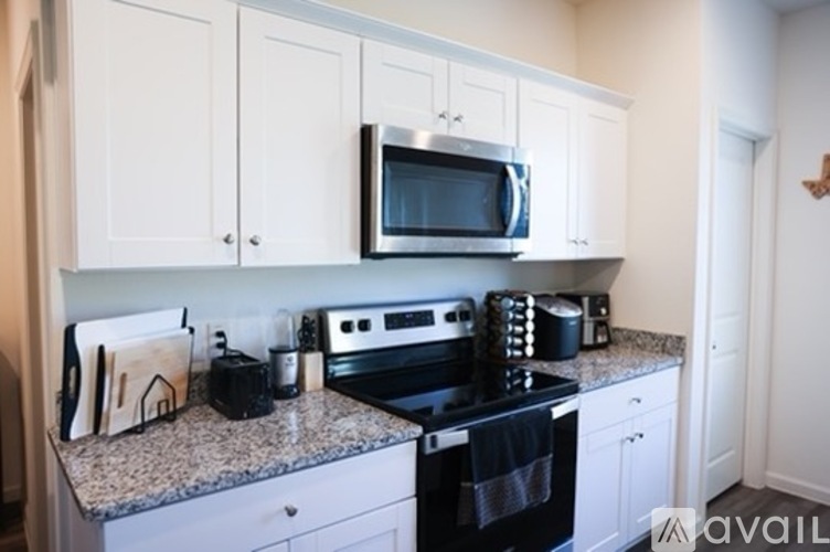 A kitchen with a black stove top oven and a black toaster.