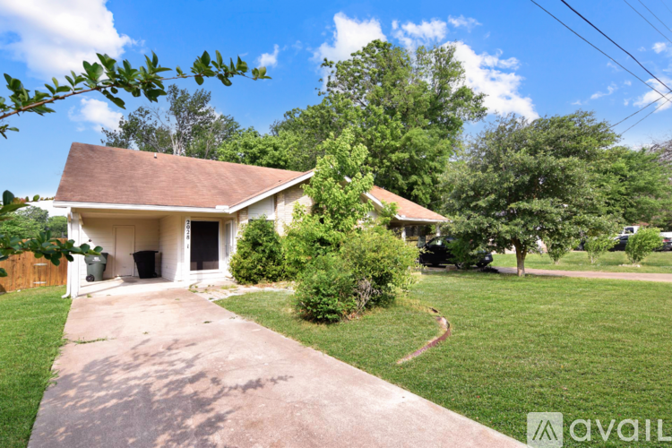 A house with a brown roof and a driveway in front.