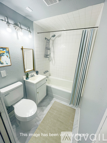 A white toilet sits next to a sink in a bathroom.