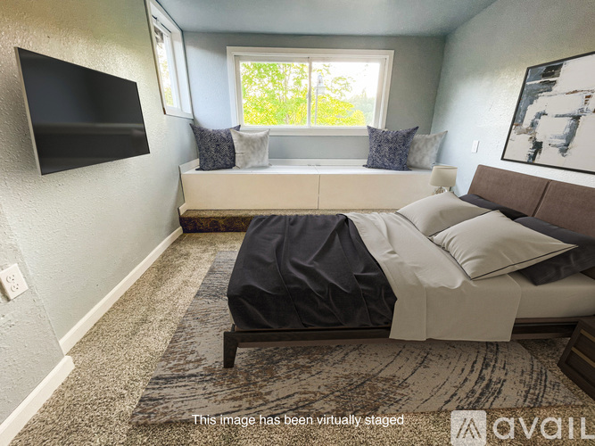 A bedroom with a bed, a couch, and a television.