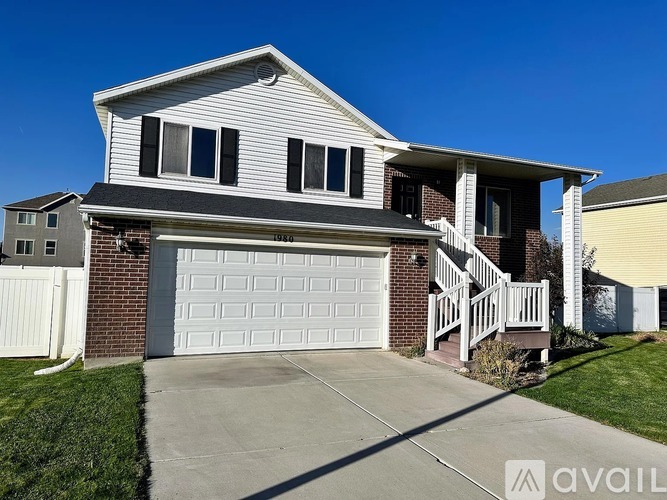 A house with a garage and a driveway in front.