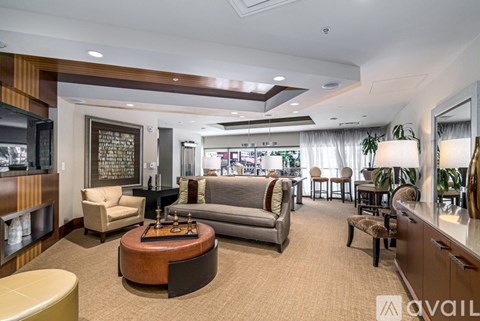 A living room with a brown carpet and furniture.