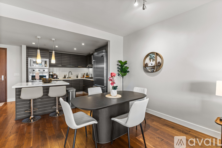 A modern kitchen with a dining table set for four.