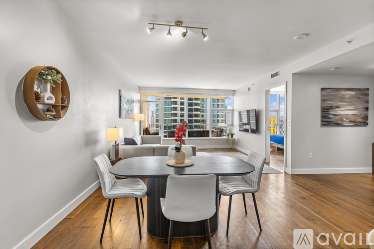 A modern dining room with a round table and chairs.