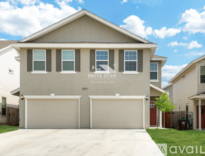 A two-story house with a garage is for sale.