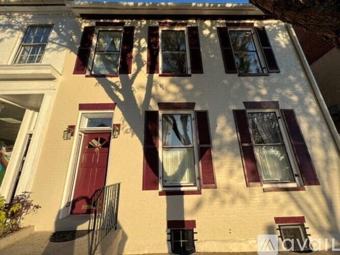 A house with a red door and red window frames.