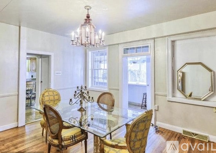 A dining room with a glass table and chairs.