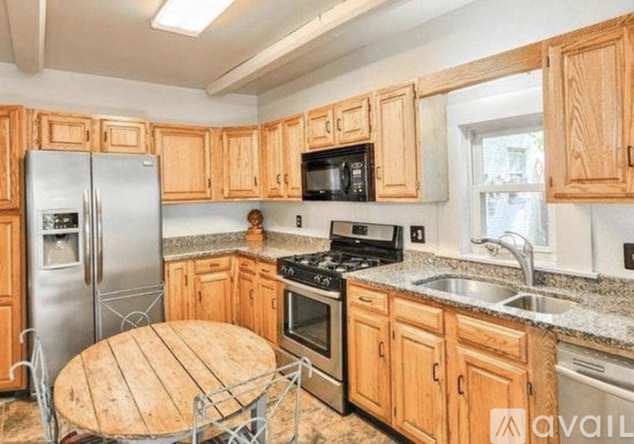 A kitchen with wooden cabinets and stainless steel appliances.