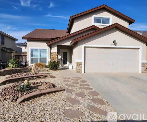 A house with a driveway and a landscaped front yard.