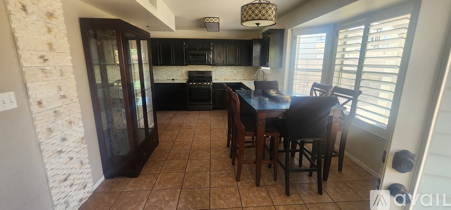 A dining room with a table and chairs.