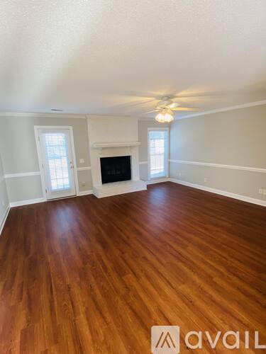 A room with wooden floors and a fireplace.