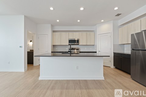 A modern kitchen with white cabinets and a central island.