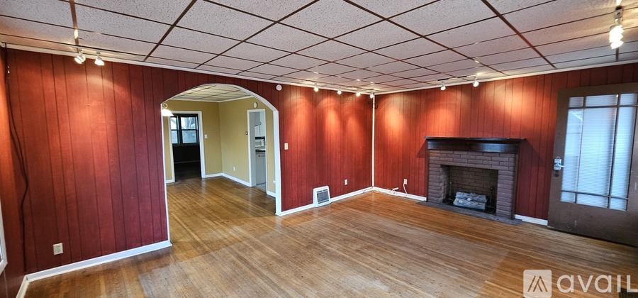 A room with red walls and a fireplace.