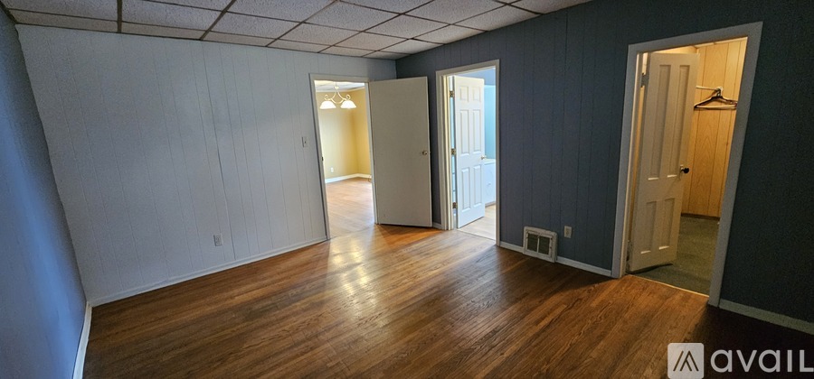 A room with wooden floors and white walls.