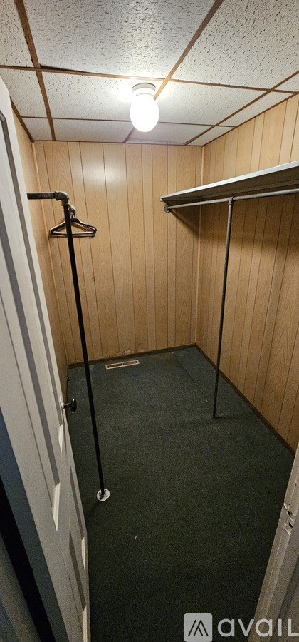A small, empty room with a shower and a shelf.