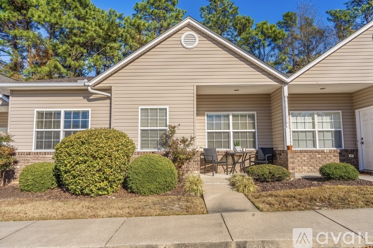 A house with a front yard and bushes.