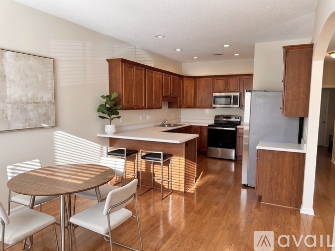 A kitchen with wooden cabinets and a white refrigerator.