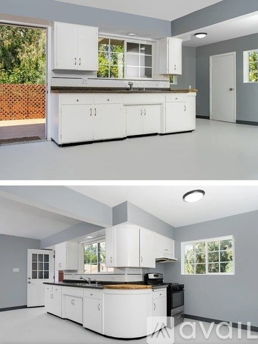A modern kitchen with white cabinets and appliances.