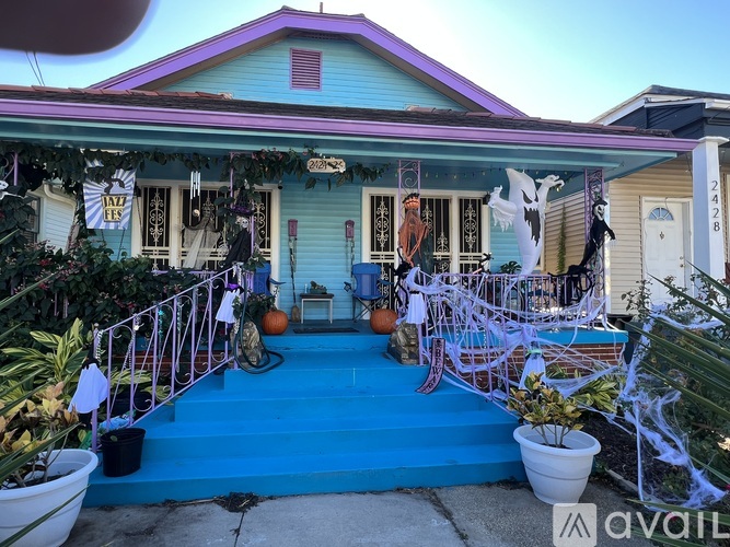 A house decorated for Halloween with a blue front porch.