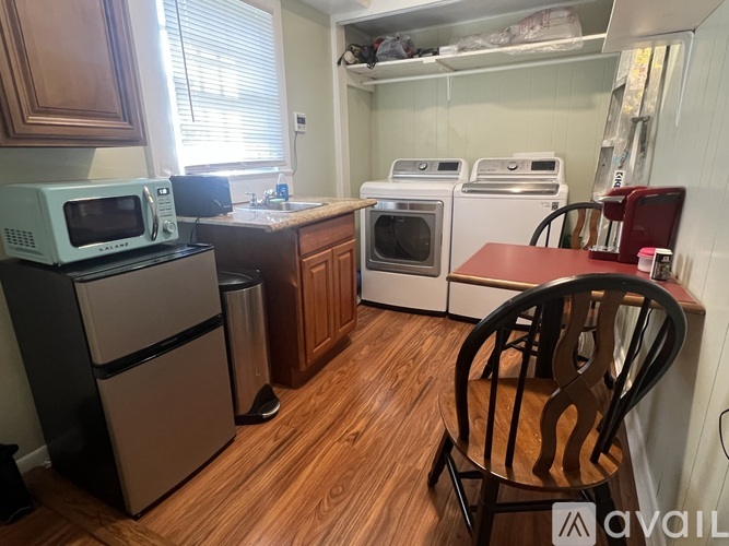 A kitchen with a microwave, oven, and refrigerator.