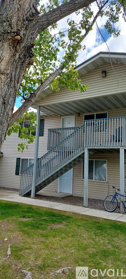 A tree is in front of a house.